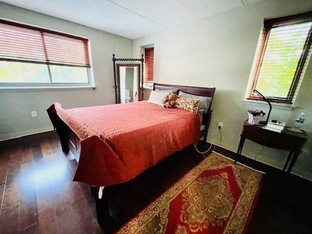 51 John St Unit 201, Brookline, MA 02446 - bedroom with wood finished floors and baseboards