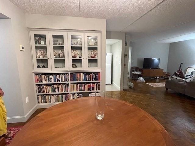 51 John St Unit 201, Brookline, MA 02446 - dining space with wood finished floors and a textured ceiling