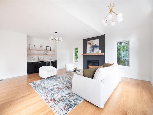 living room with a chandelier and light hardwood / wood-style floors