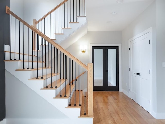 entryway featuring french doors and light hardwood / wood-style flooring