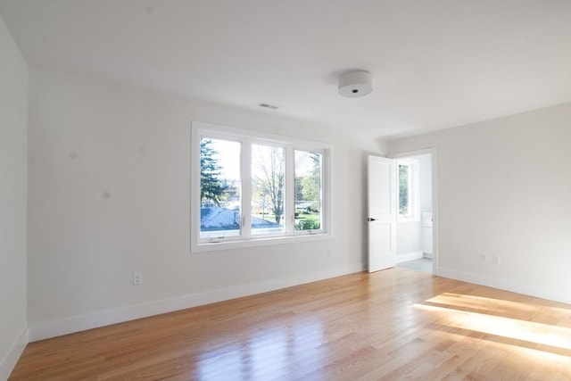 spare room with light hardwood / wood-style flooring