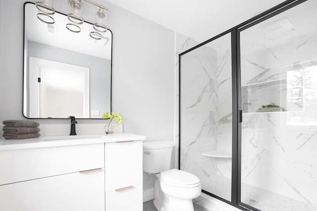 bathroom with vanity, an enclosed shower, and toilet