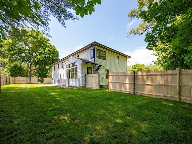 rear view of property with a lawn