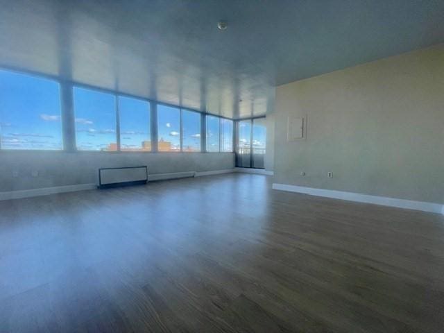 empty room featuring dark hardwood / wood-style flooring