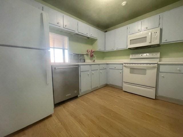 kitchen featuring white cabinetry, sink, white appliances, and light wood-type flooring