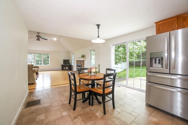 10 Morgan Cir, Holden, MA 01520 - dining room featuring stone tile flooring, a ceiling fan, baseboards, a glass covered fireplace, and lofted ceiling