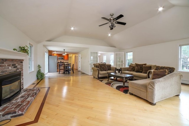 10 Morgan Cir, Holden, MA 01520 - living area with lofted ceiling, ceiling fan, a fireplace, and light wood-style flooring