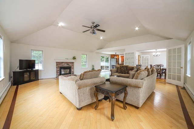 10 Morgan Cir, Holden, MA 01520 - living room featuring lofted ceiling, a chandelier, a fireplace, light wood-style floors, and ceiling fan