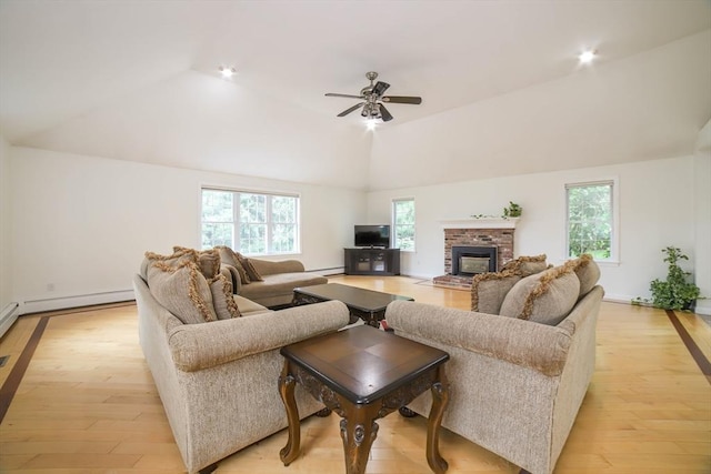 10 Morgan Cir, Holden, MA 01520 - living room featuring lofted ceiling, a ceiling fan, light wood-style flooring, a fireplace, and baseboards