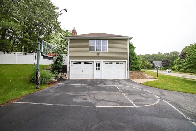 10 Morgan Cir, Holden, MA 01520 - view of side of home featuring asphalt driveway, a chimney, and an attached garage