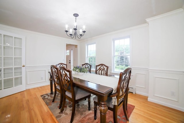 10 Morgan Cir, Holden, MA 01520 - dining area featuring light wood-style floors, a chandelier, a decorative wall, a wainscoted wall, and crown molding