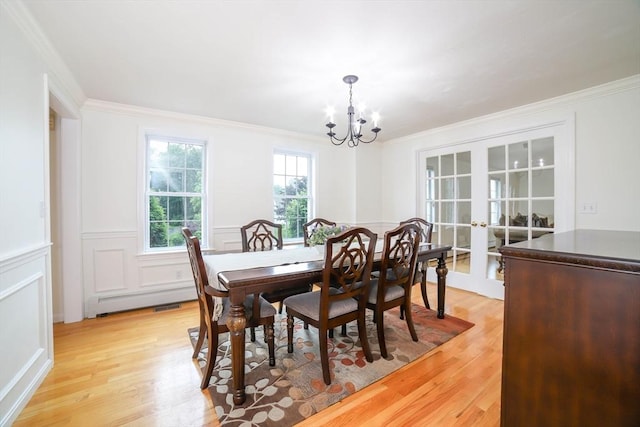 10 Morgan Cir, Holden, MA 01520 - dining area with light wood finished floors, a chandelier, crown molding, french doors, and a baseboard heating unit