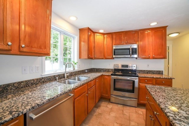 10 Morgan Cir, Holden, MA 01520 - kitchen featuring appliances with stainless steel finishes, a sink, dark stone countertops, light stone finish flooring, and recessed lighting