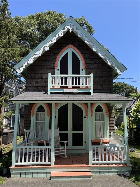 back of house with covered porch and a balcony