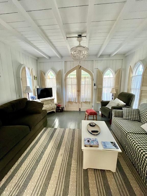 sunroom with beamed ceiling and french doors