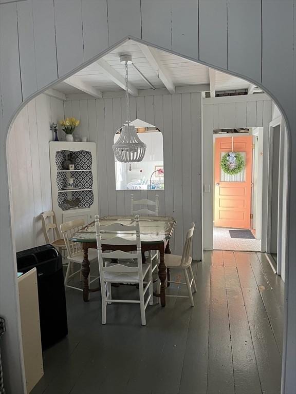 dining space featuring beam ceiling and wood-type flooring