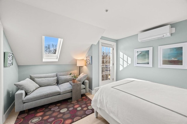 bedroom featuring lofted ceiling with skylight and a wall mounted AC