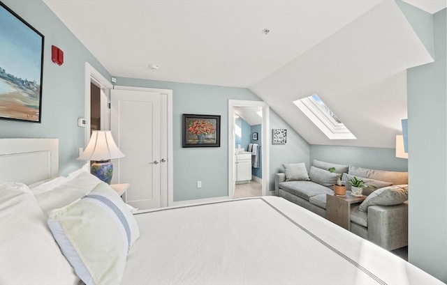 bedroom with lofted ceiling and ensuite bathroom