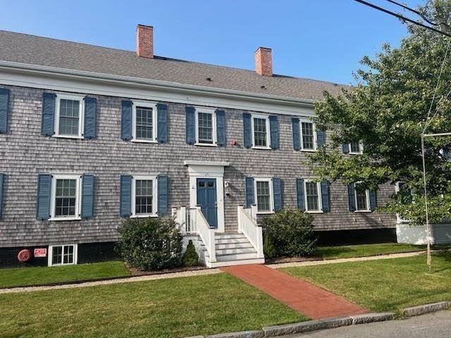 colonial home with a front lawn