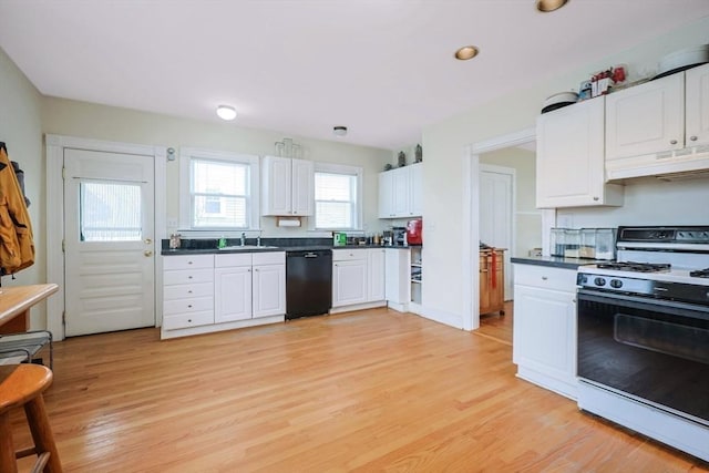 kitchen with dark countertops, under cabinet range hood, black dishwasher, gas stove, and a sink