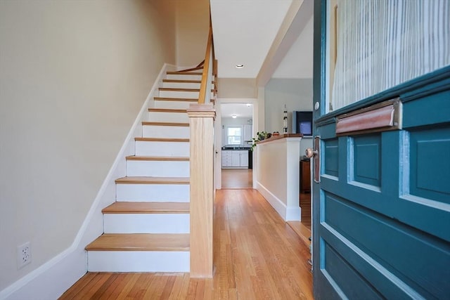 stairs featuring wood finished floors