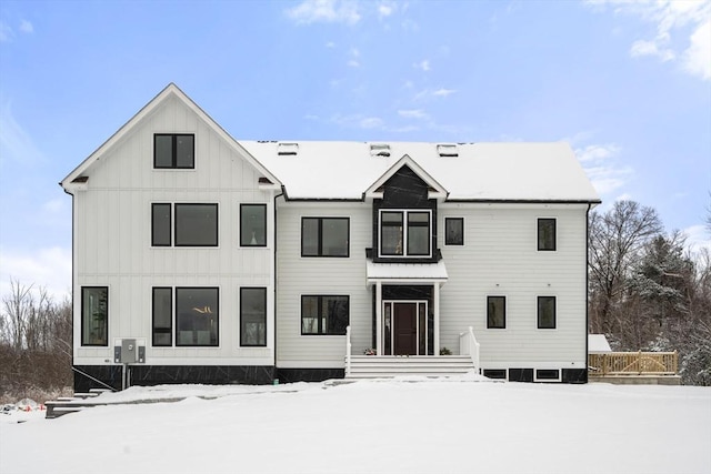 view of snow covered rear of property