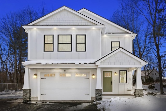 modern inspired farmhouse featuring board and batten siding, a porch, and a garage