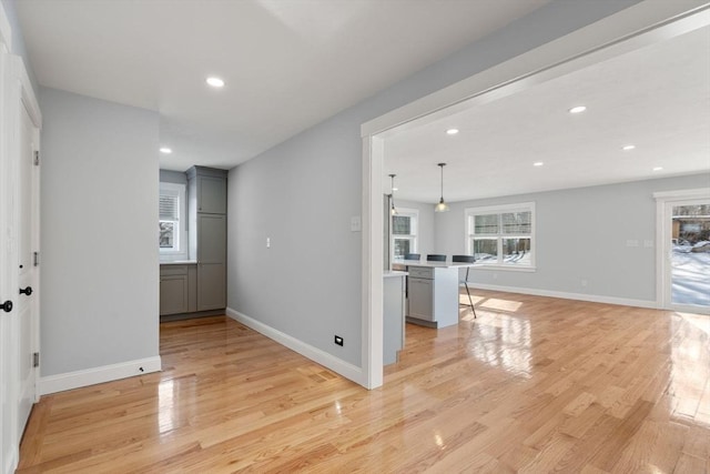 interior space with light wood-style floors, recessed lighting, light countertops, and gray cabinetry