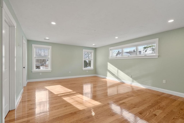 empty room featuring baseboards, recessed lighting, and light wood-style floors