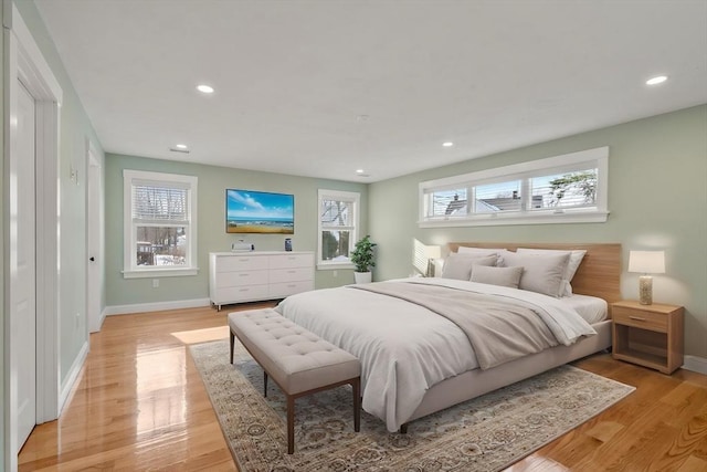 bedroom featuring light wood-style flooring, multiple windows, and recessed lighting