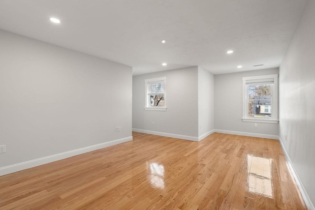 unfurnished room with recessed lighting, light wood-style flooring, and baseboards