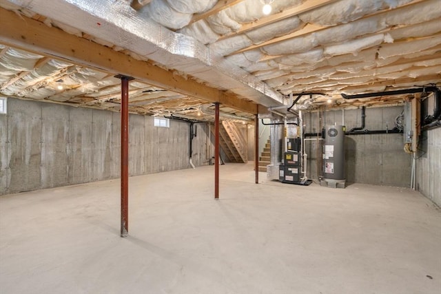 unfinished below grade area featuring water heater, stairs, and heating unit