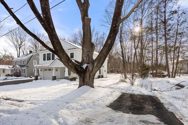 view of front of home with board and batten siding, a chimney, and a garage