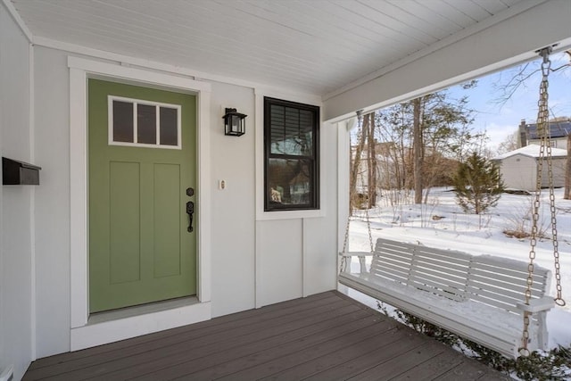 view of snow covered property entrance