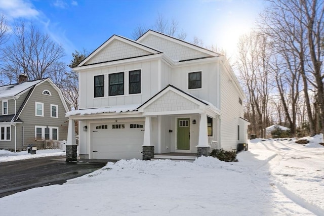 view of front facade featuring an attached garage, driveway, and board and batten siding