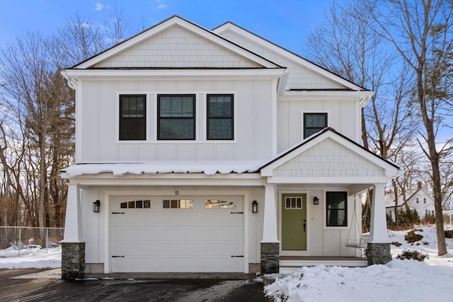 modern farmhouse style home featuring covered porch, driveway, board and batten siding, and an attached garage