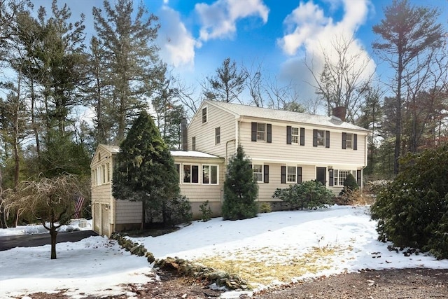 colonial-style house featuring a chimney