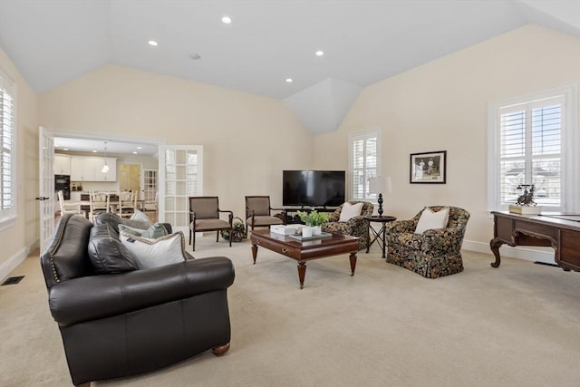 carpeted living room with lofted ceiling