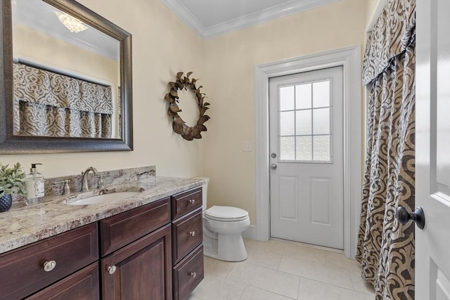 bathroom featuring tile patterned floors, toilet, vanity, and ornamental molding