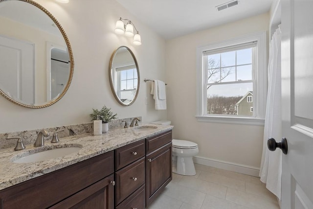 bathroom featuring toilet and vanity