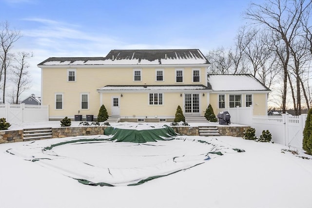 view of snow covered back of property