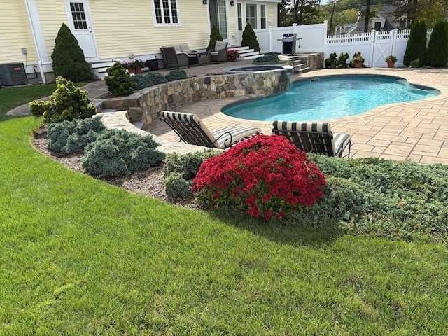 view of pool with area for grilling, central air condition unit, a patio, and a yard