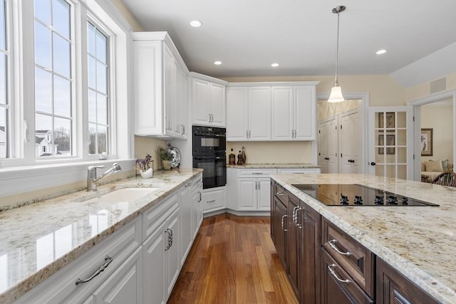 kitchen with black appliances, white cabinetry, dark brown cabinets, sink, and dark hardwood / wood-style floors