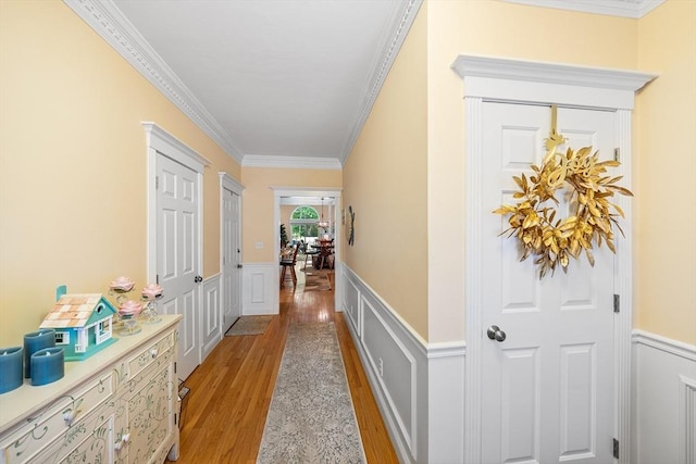 51 Spruce St Unit 51, Northbridge, MA 01534 - hallway featuring light wood finished floors, wainscoting, ornamental molding, and a decorative wall