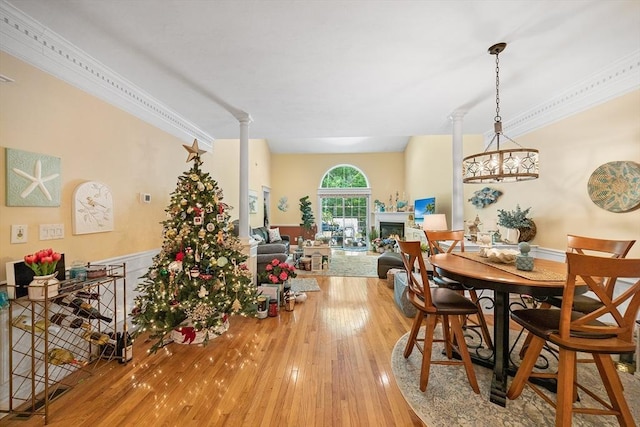 51 Spruce St Unit 51, Northbridge, MA 01534 - dining room with wood-type flooring, crown molding, a fireplace, and ornate columns