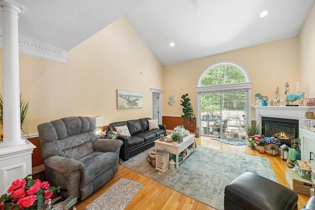 51 Spruce St Unit 51, Northbridge, MA 01534 - living area featuring decorative columns, wood finished floors, a warm lit fireplace, high vaulted ceiling, and recessed lighting