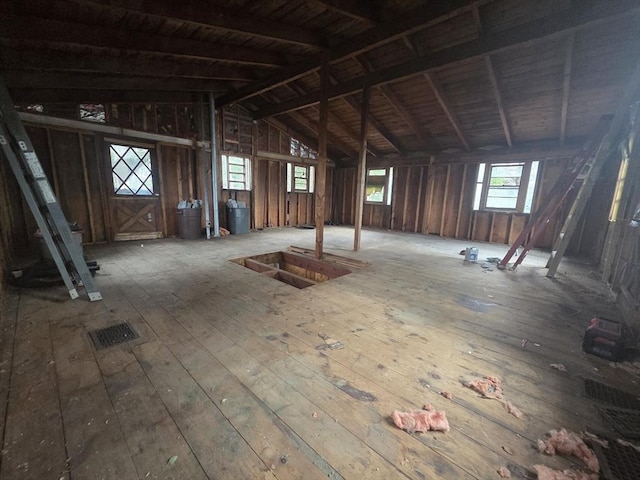 misc room featuring wood-type flooring and vaulted ceiling