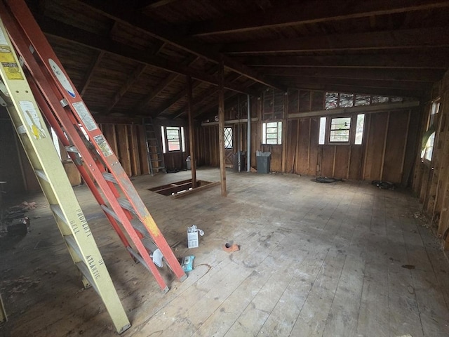 miscellaneous room featuring wood-type flooring and lofted ceiling