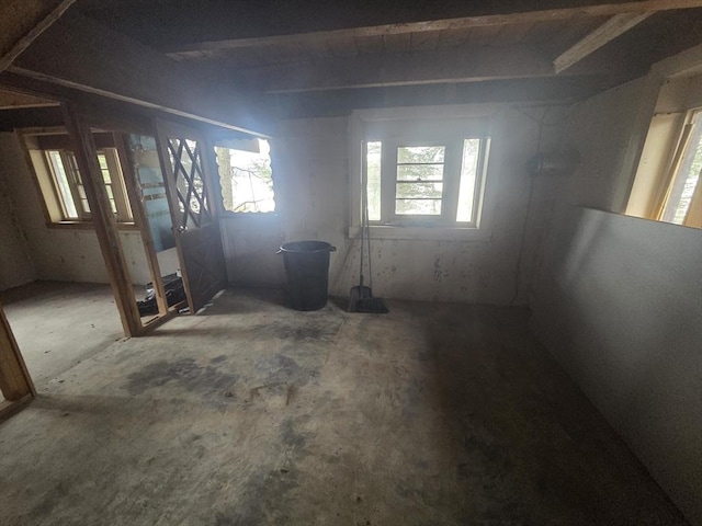 unfurnished room featuring beam ceiling