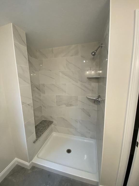 bathroom with tiled shower